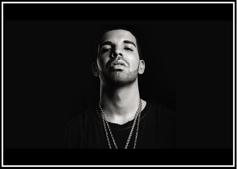 Monochrome portrait of a confident man wearing layered necklaces.